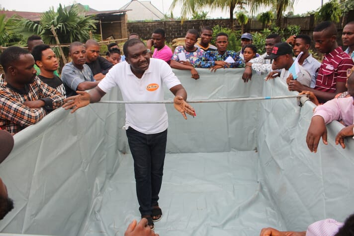 Israel Yusuf training fish farmers, using a demo pond in Uyo Akwa Ibom, in the Niger Delta