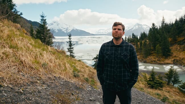 A man standing on a hillside.