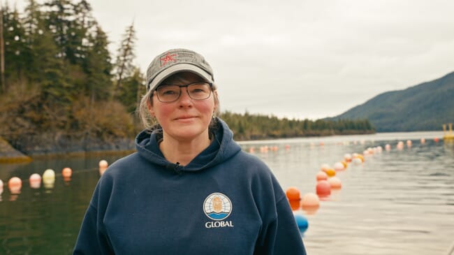 A woman standing on the deck of a boat.