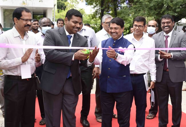 man cutting a ceremonial ribbon