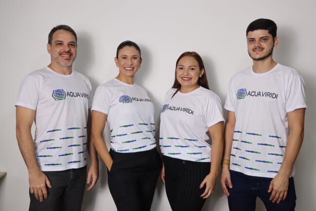 Four people wearing white t-shirts.
