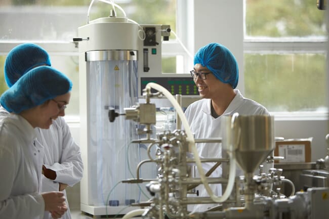 Three people in a lab.