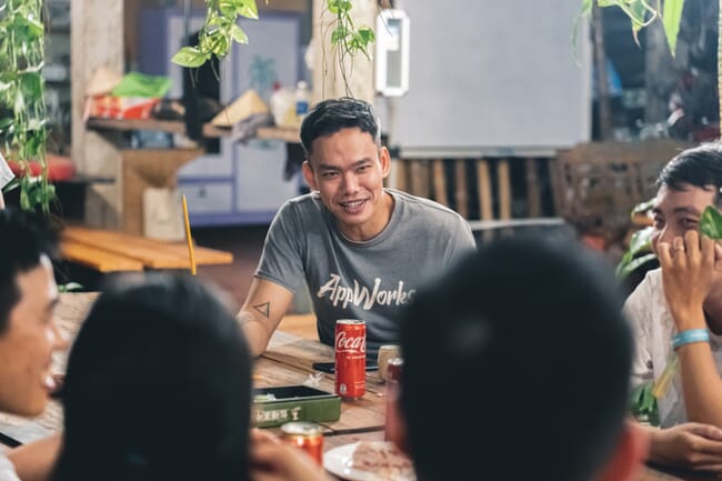 People having a discussion around a table.