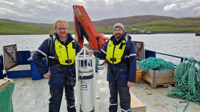 Researchers with a phytoplankton detection device.