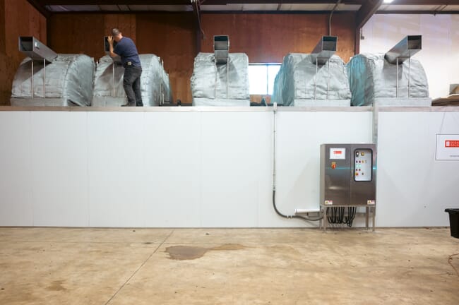 A person inspecting an industrial machine.