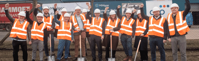 A group of people holding spades.