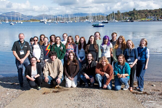 A group photo beside the sea.