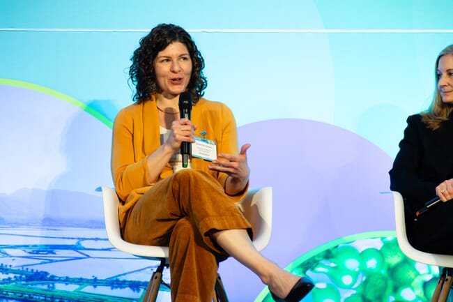 A woman speaking into a microphone.