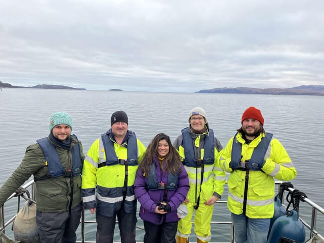 A group of people beside the sea.