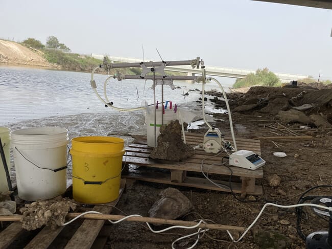 A selection of scientific equipment beside a waterway.