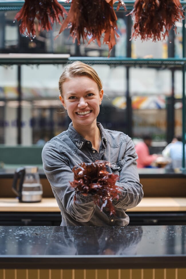 A woman holding seaweed.