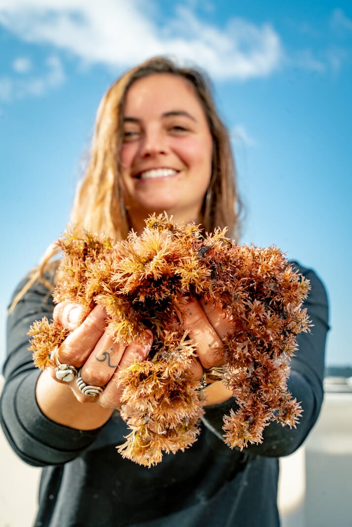 a lady holding a handful of seaweed