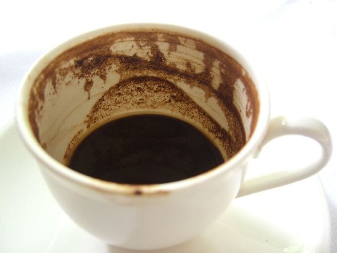 white mug with coffee grounds