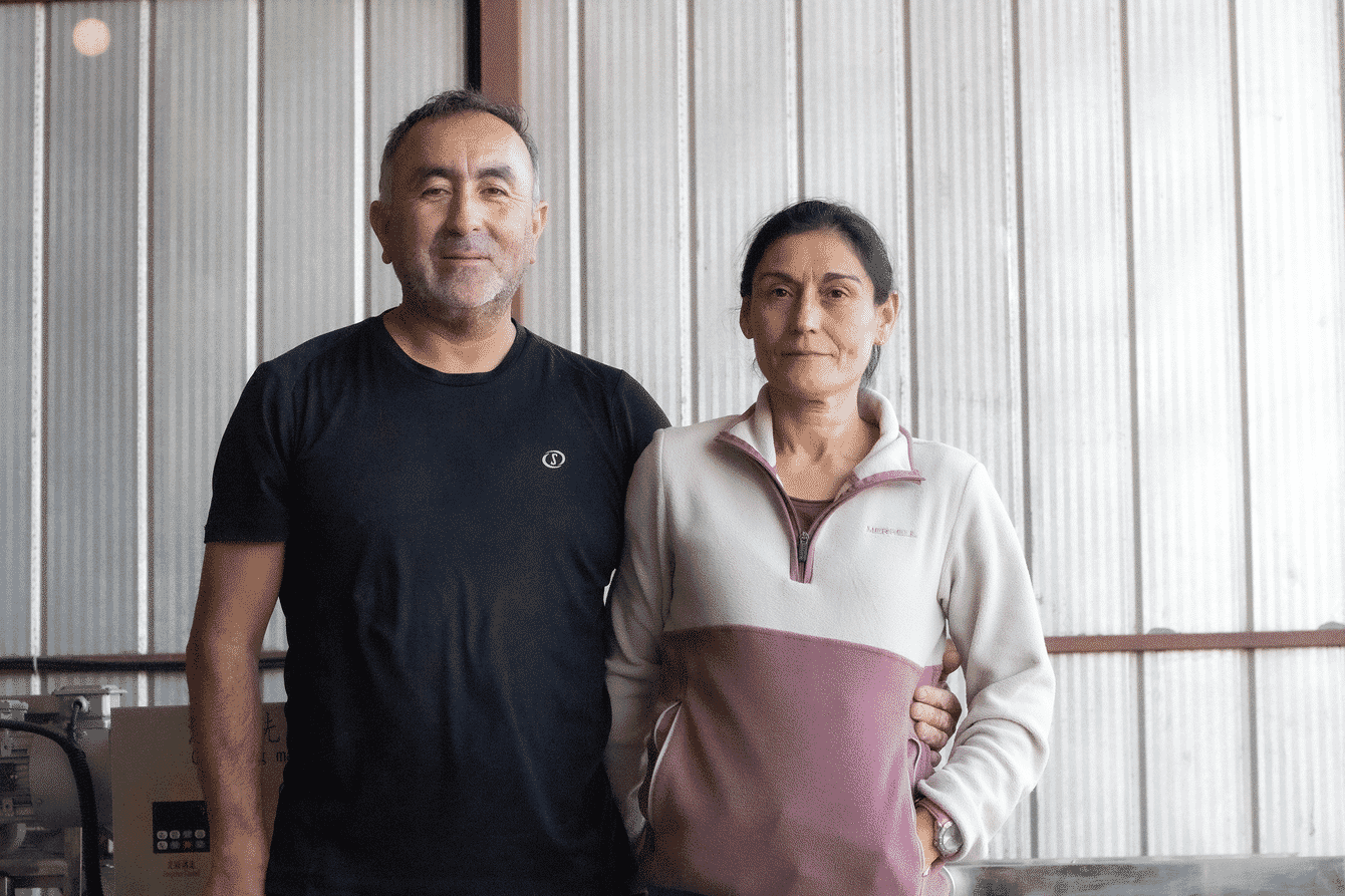 A couple standing in a shed.