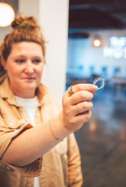 Katie Weiler holding twine made from a seaweed polymer