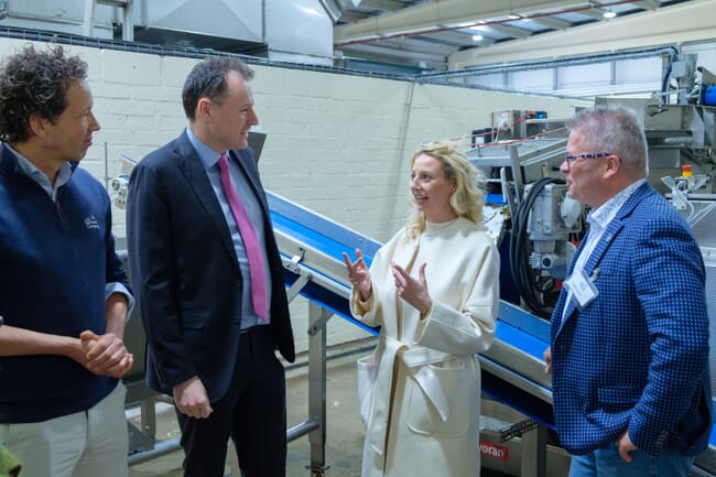 Four people inside a factory.