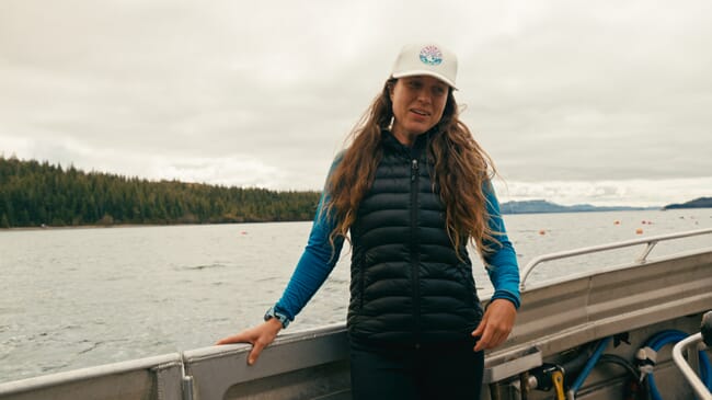 A woman standing on the deck of a boat.