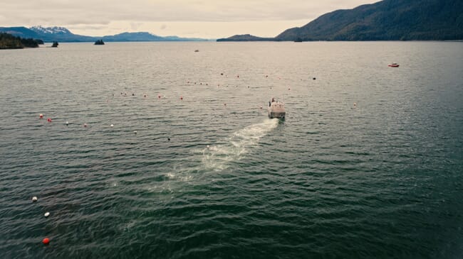 An aerial view of a boat in a fjord.