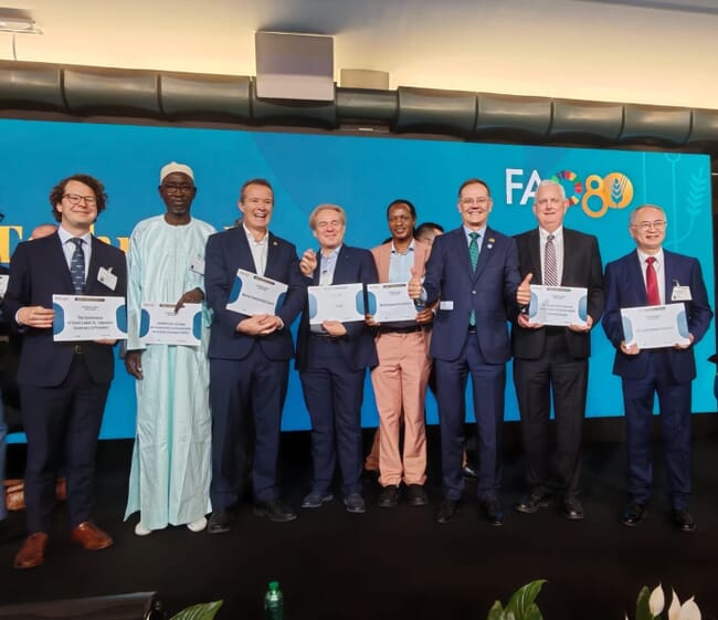 A group of people receiving a United Nations award during an event.