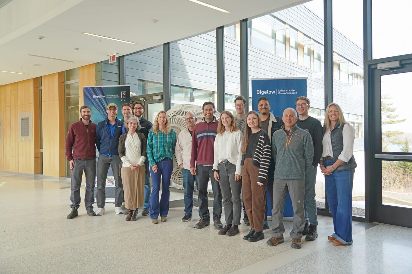 A group of people posing for a photo at a studio focusing on marine biotechnologies.