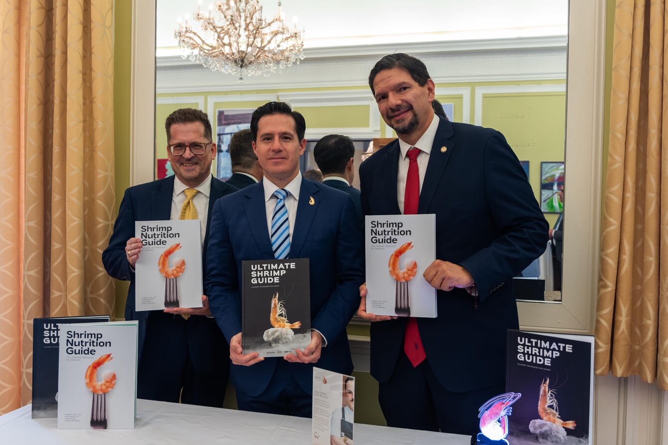 A group of three men at a formal event showcasing Ecuadorian shrimp.