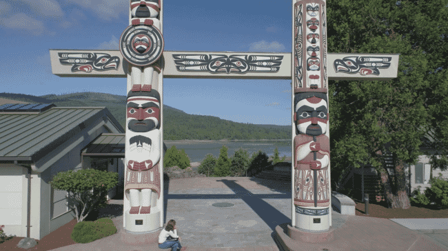 A photo of Indigenous statues near a lake in the USA.