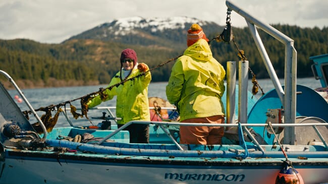 Two people on the deck of a boat.