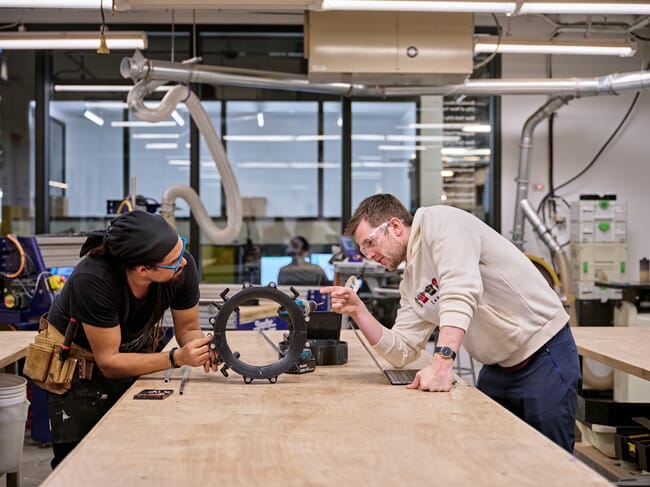 Two engineers working in a lab to develop a carbon capture method.