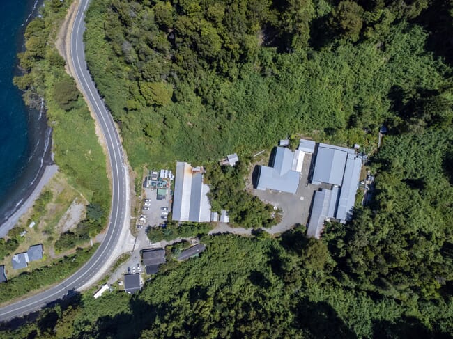 aerial view of a salmon hatchery beside a river