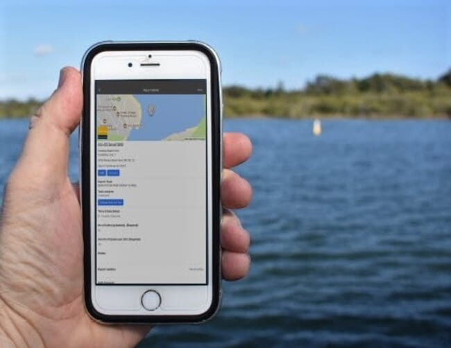 an oyster farmer using an app on a smartphone
