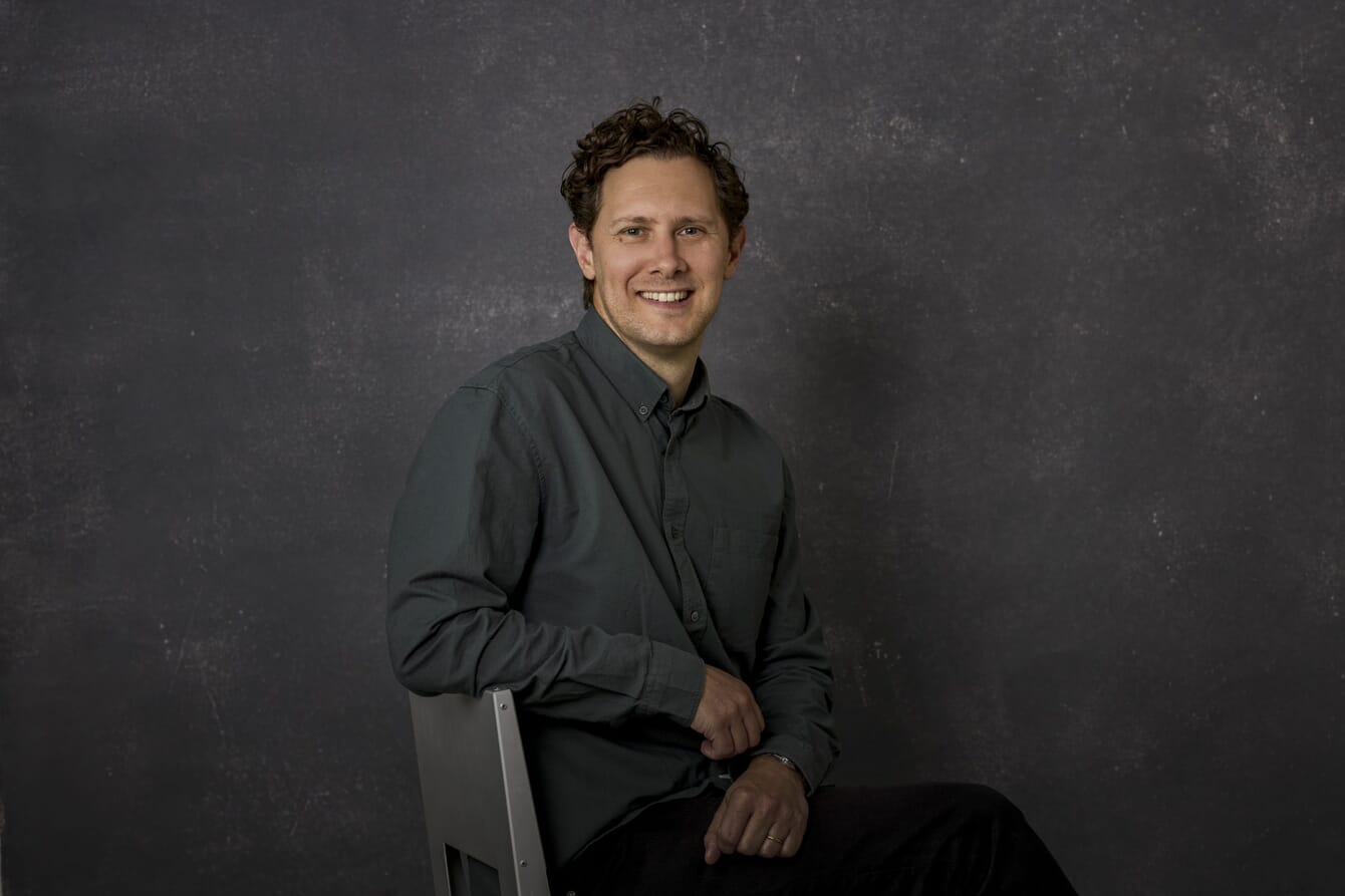 A man sitting in a suit.