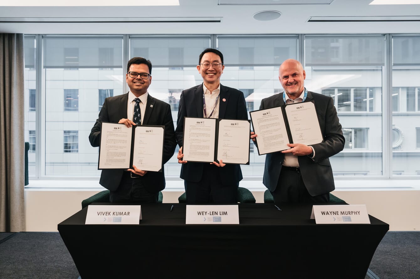 Three company representatives signing the launch of a Blue Carbon innovation challenge.