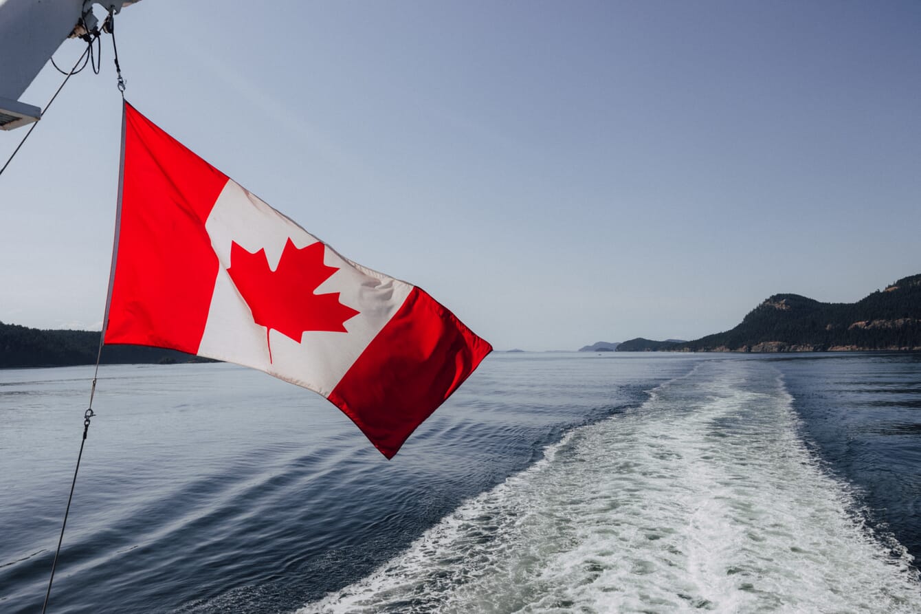 A Canadian flag drifting through the air from a speed boat.