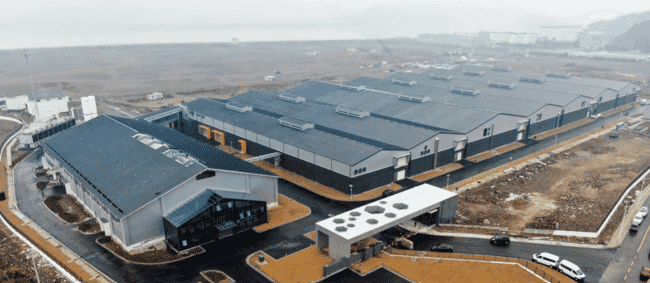 Aerial view of the exterior of an indoor salmon farm.