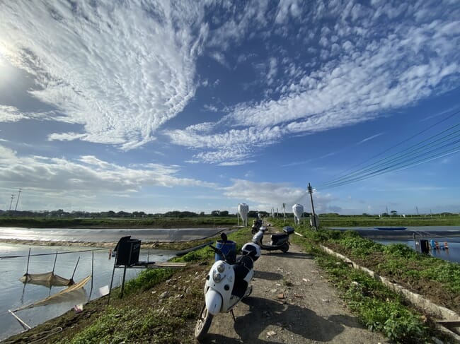 tilapia pond with a motorcycle in the foreground