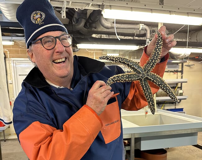 A man holding a starfish.