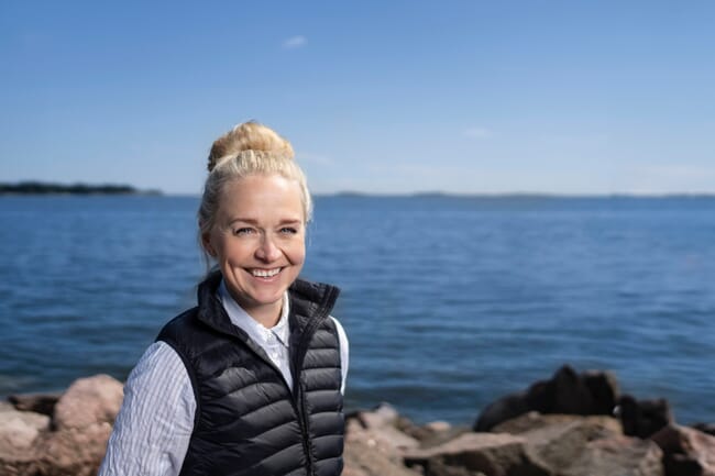 A woman standing beside the sea.