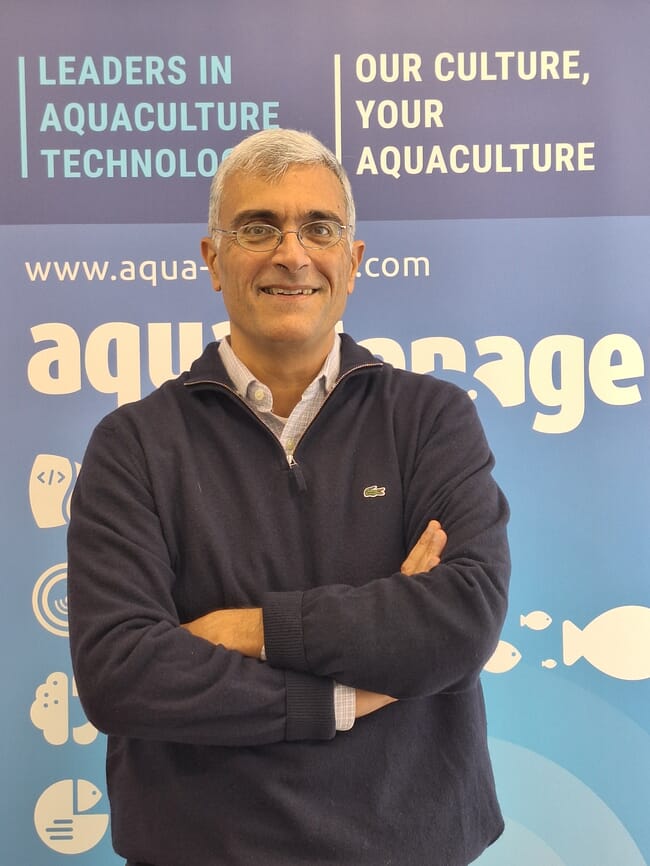 A man standing in front of a poster.