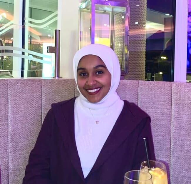 A lady sitting at a table in a restaurant