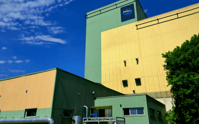 A aquaculture feed company photographed from the outside on a sunny day.