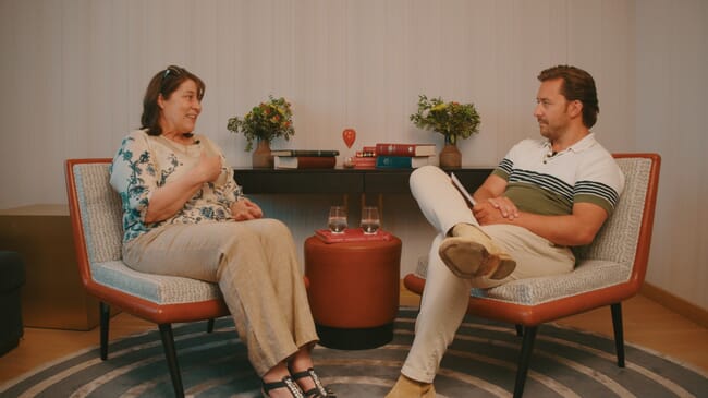 Two people having a seated discussion.