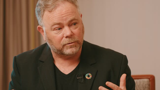 A man delivering a point in a discussion.