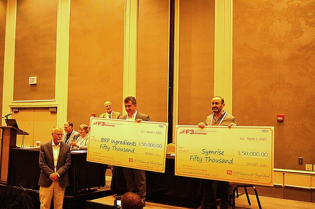 Two people holding up giant cheques.