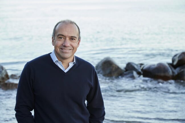 Man stands in front of sea.