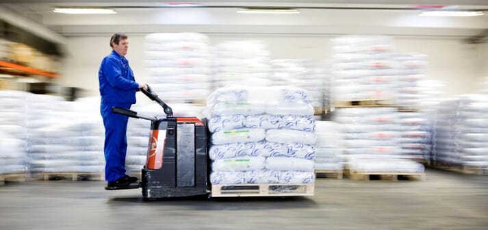 person moving aquafeed bags with a forklift