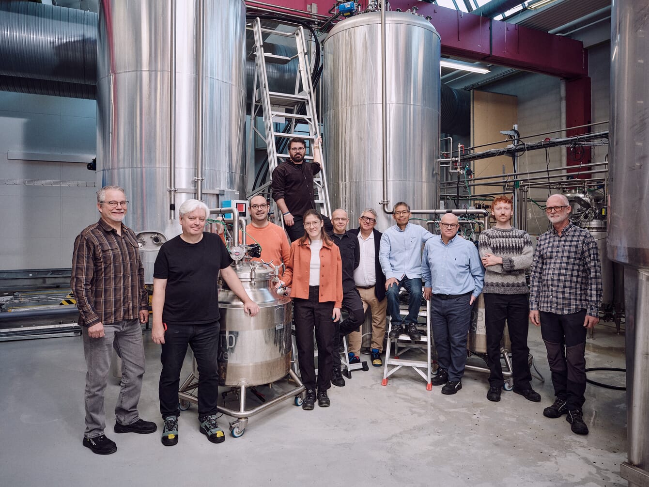 A group photo inside a factory.