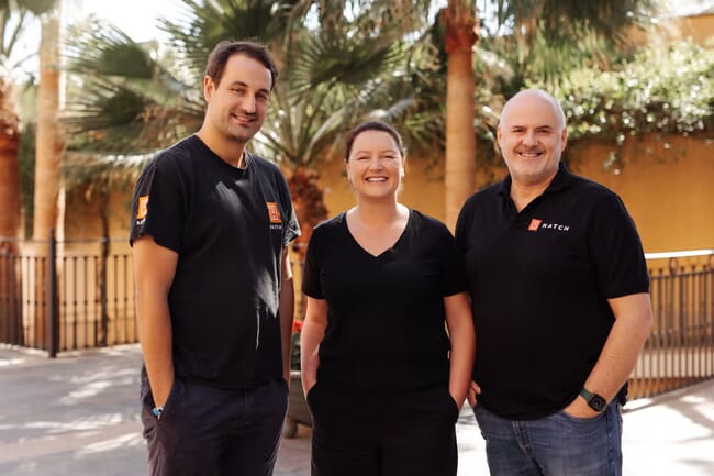 Three people dressed in black posing for a photo.