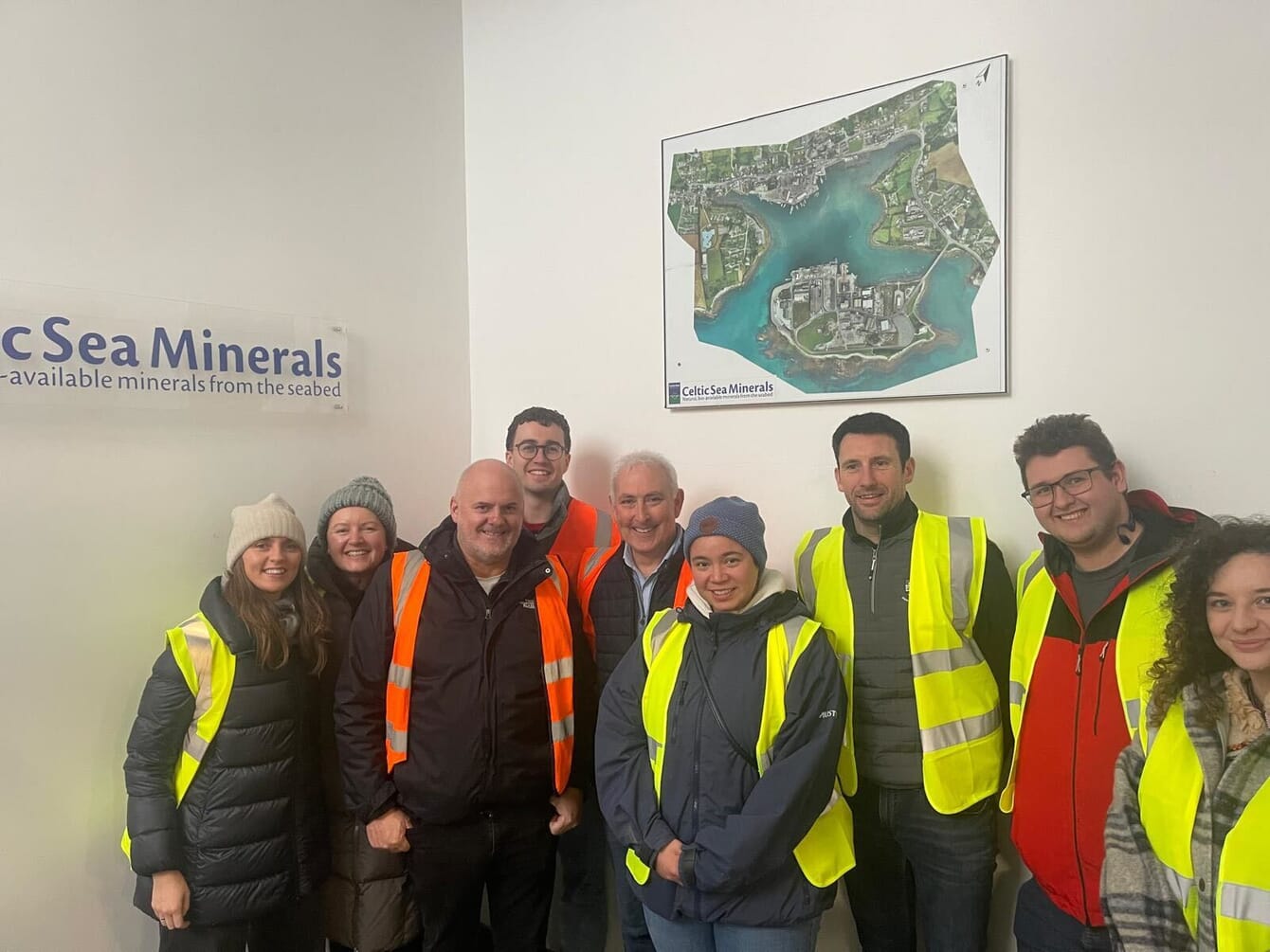 A group photo of people in high-viz waistcoats.