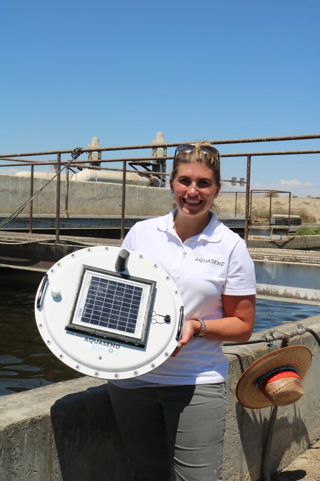 A woman holding up a sensor.