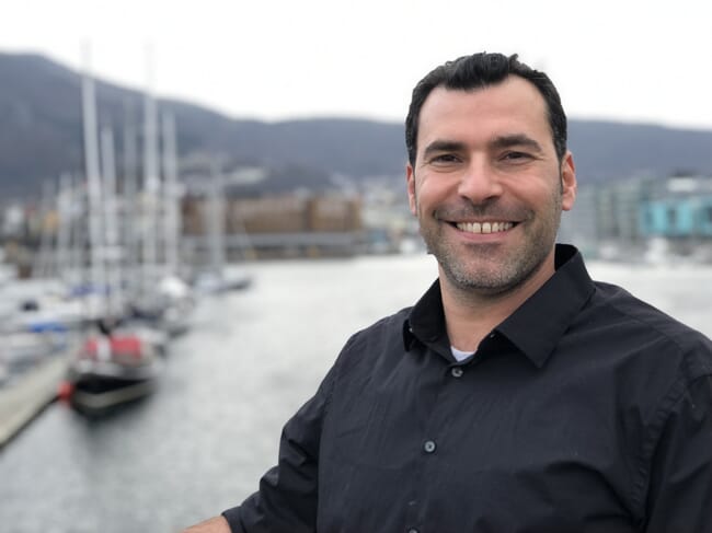 a man standing in front of some boat